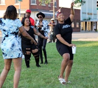 a group of people playing frisbee in a park